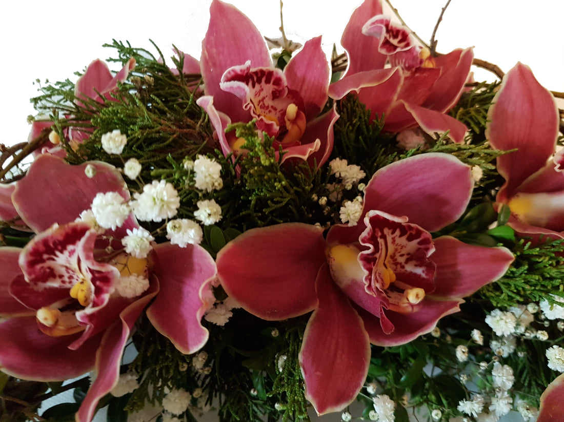 Kranz zur Beerdigung rötliche Orchideen je nach Verfügbarkeit - Cymbiedea oder Phalaenopsis - Moderner Trauerschmuck auch für Urne geeignet